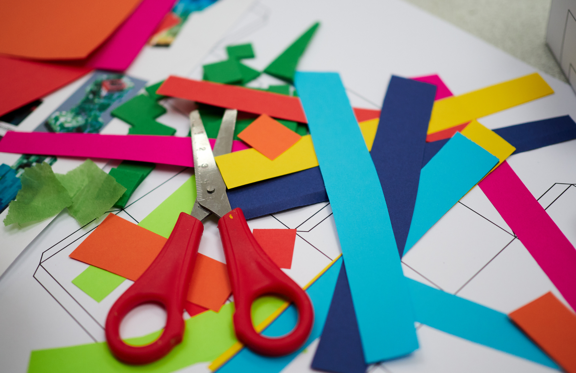 Scissors and cut up multi-colored craft paper
