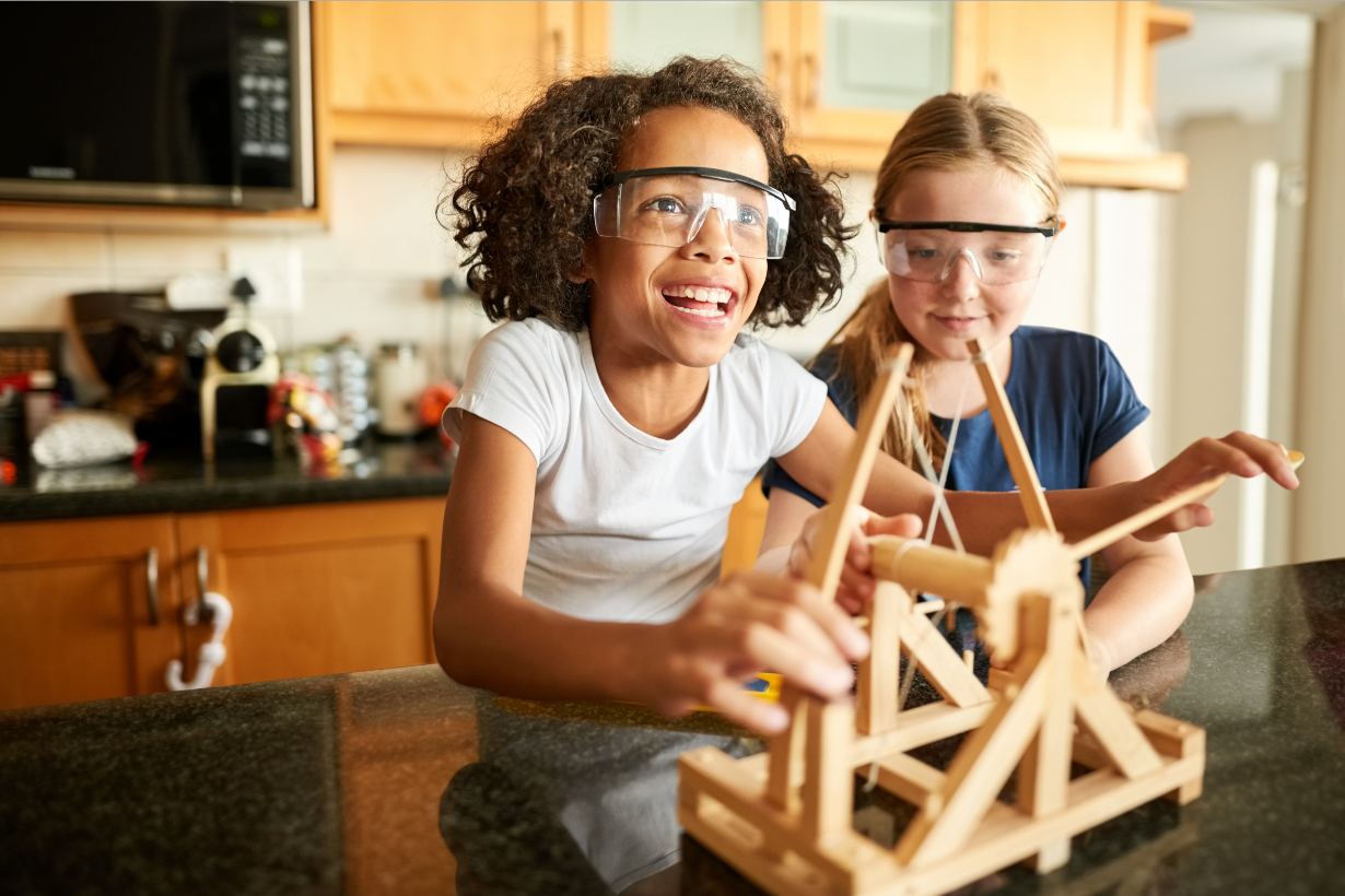 Image of kids/tweens building a wooden catapult