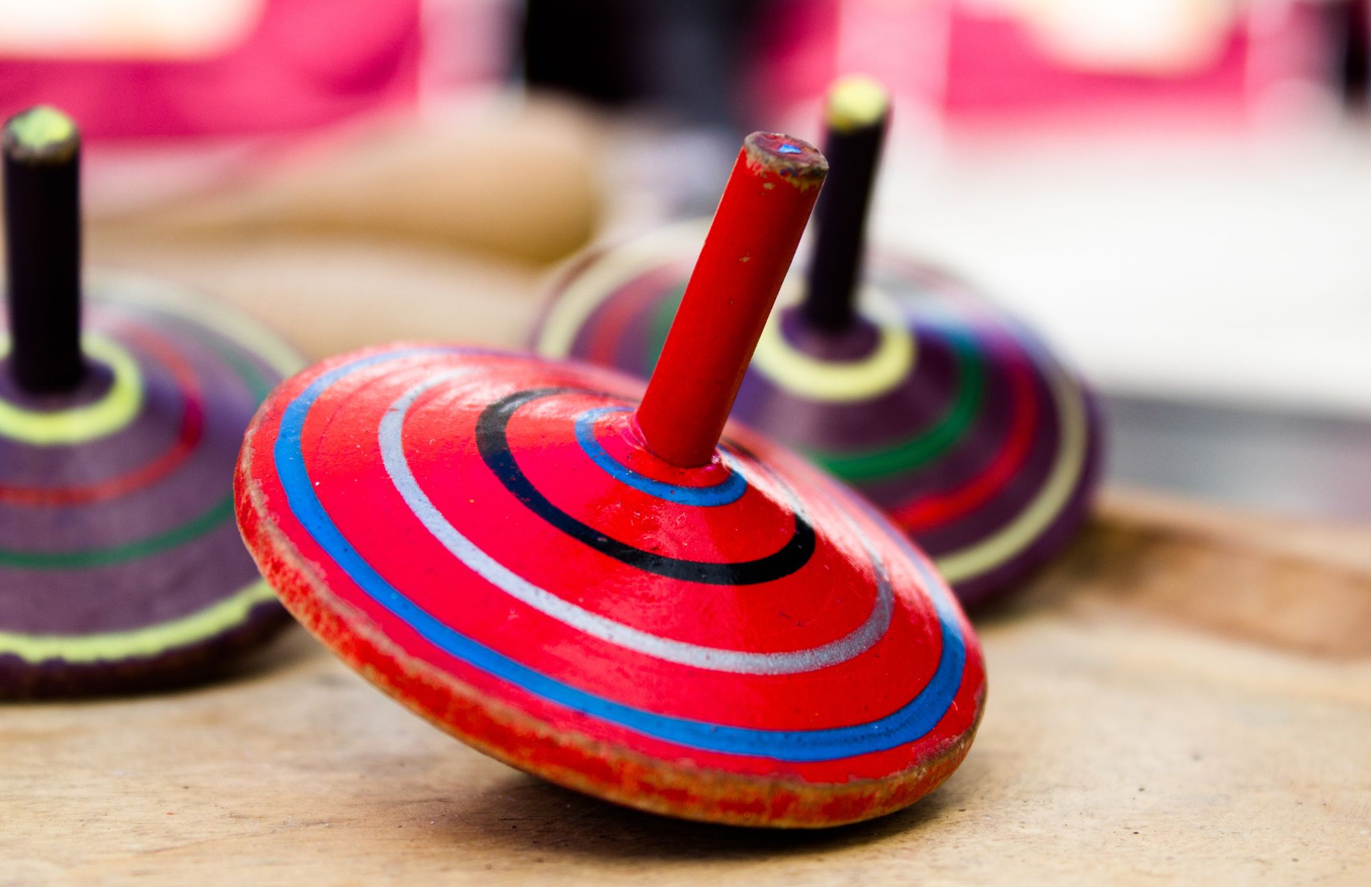 Three colorful striped spinning tops