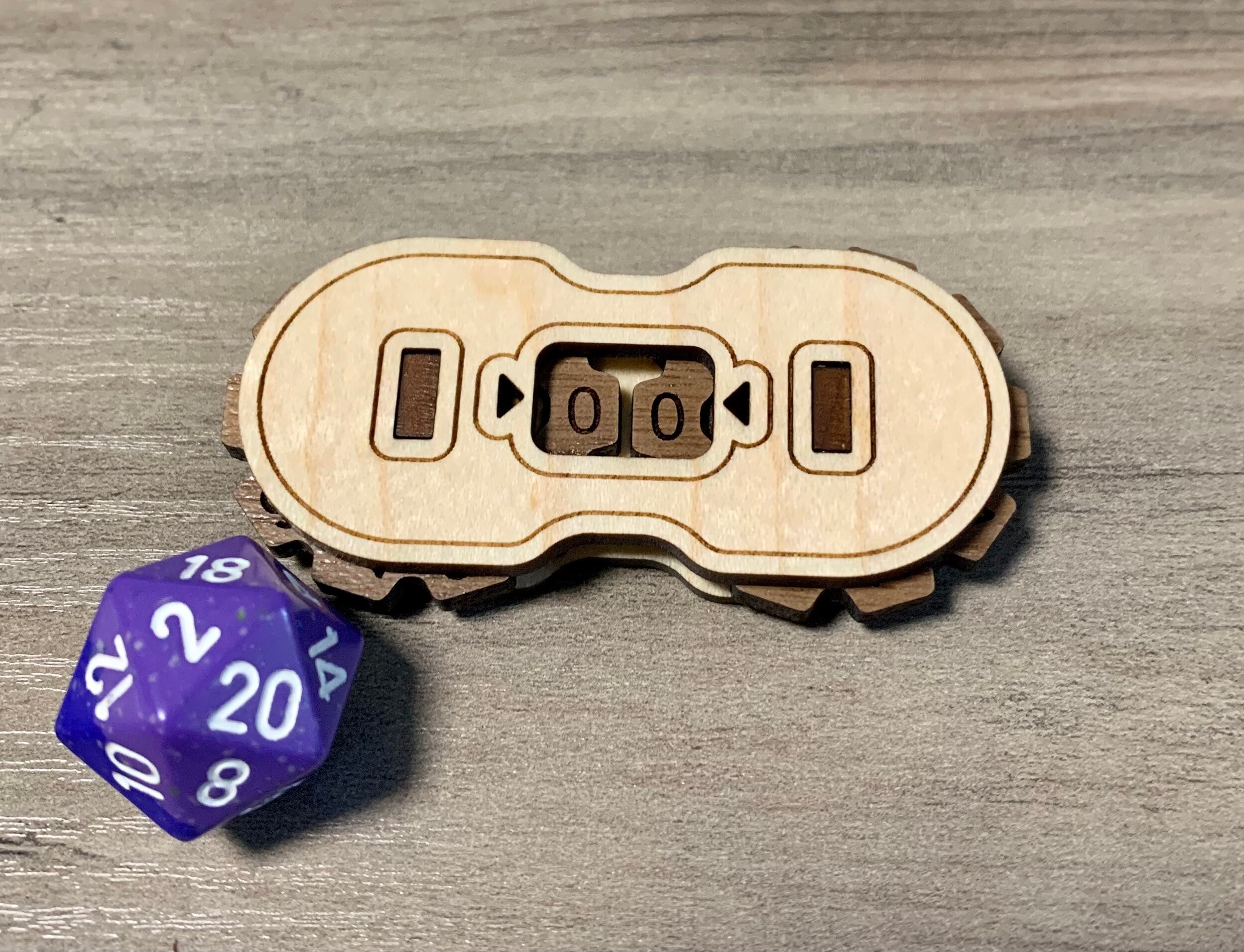 wooden magic the gathering life counter next to a d20