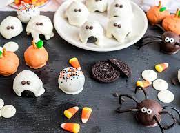 chocolate truffles decorated as ghosts, pumpkins, ghosts, and spiders