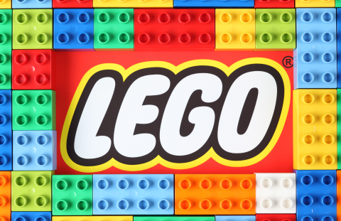 LEGO logo with colorful bricks in background