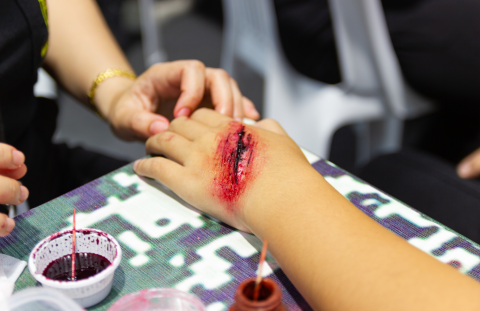 The back of a hand with a fake bloody wound