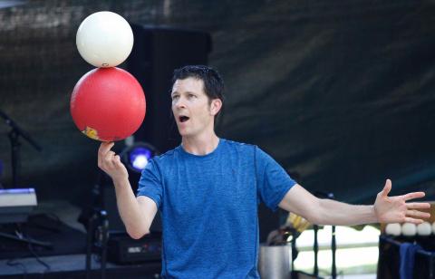 Bryson balancing two balls stacked on top of each other on his fingers