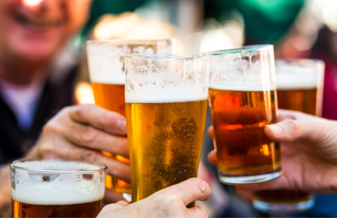 people holding glasses of beer