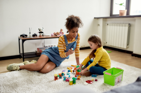 babysitter and child playing