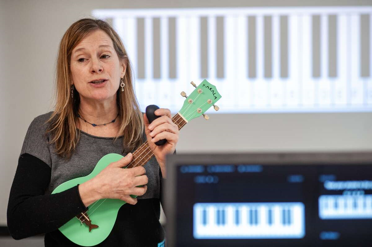 woman playing ukulele