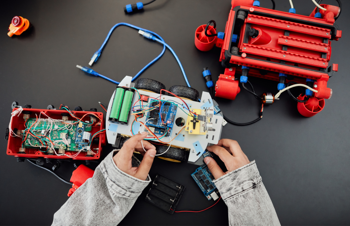 Child building a robotic creature.